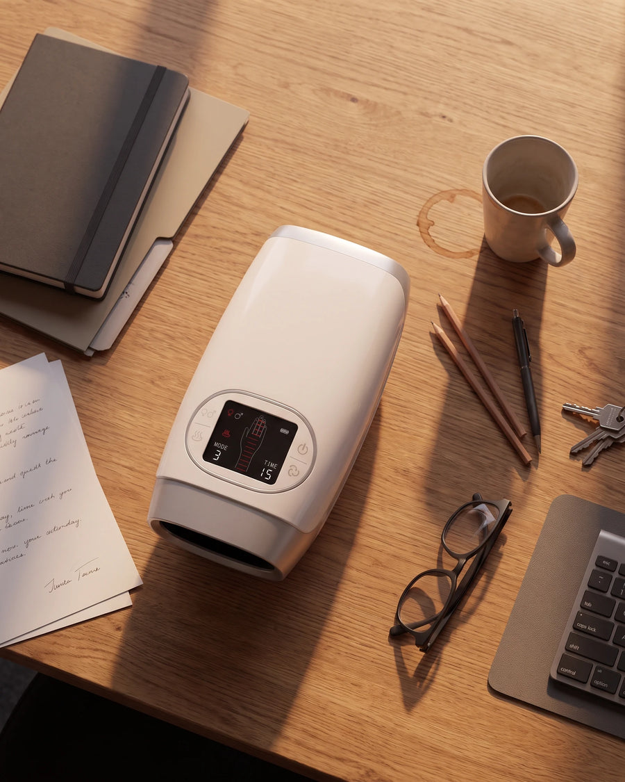 The heated hand massager — on a desk among the things of the day