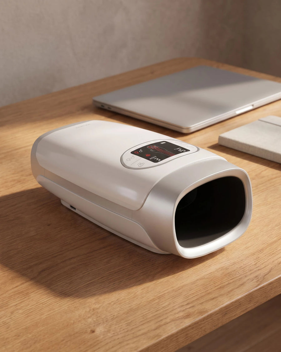 The heated hand massager — at rest on a working desk