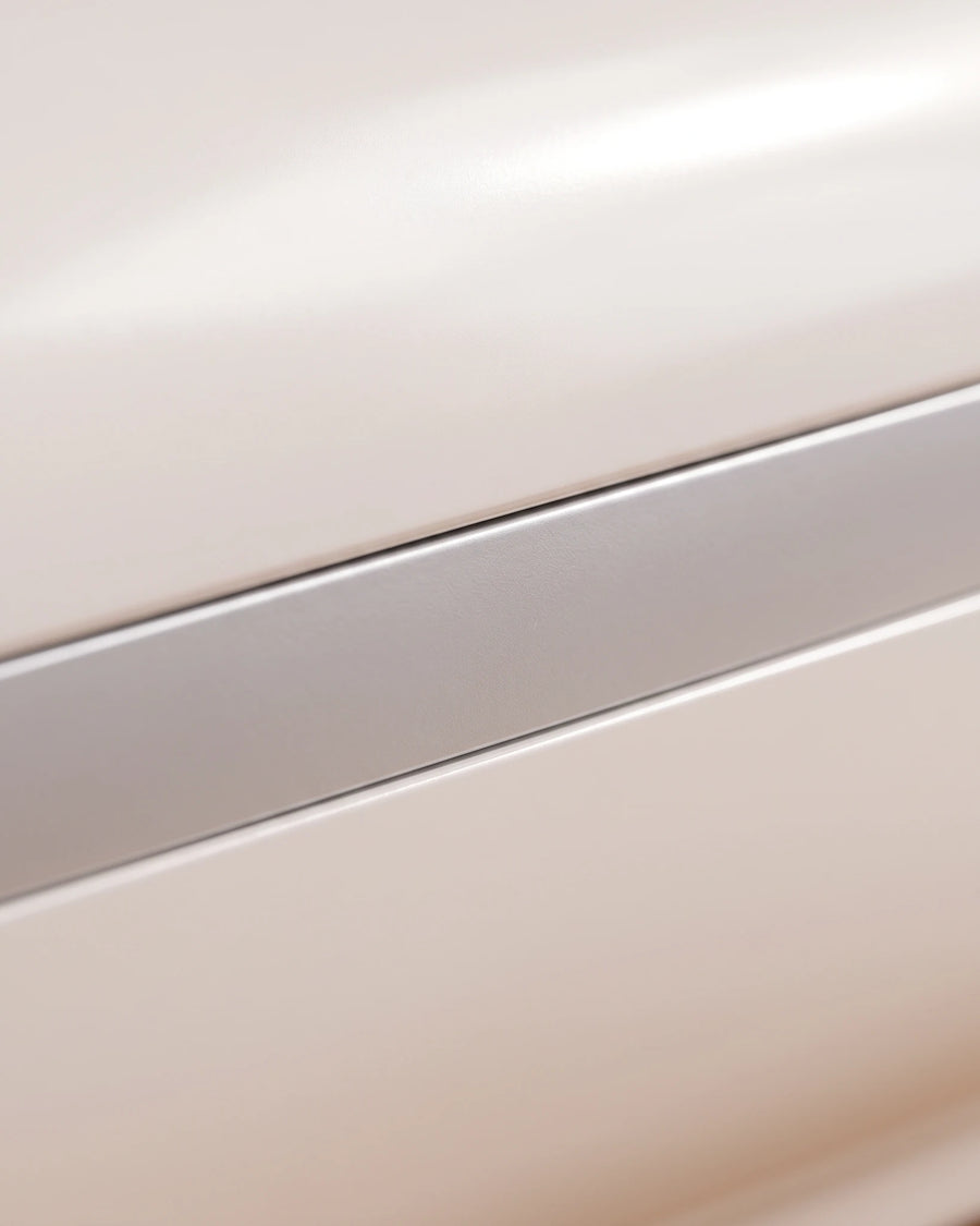 The heated hand massager — the painted shell and the aluminum girdle, close