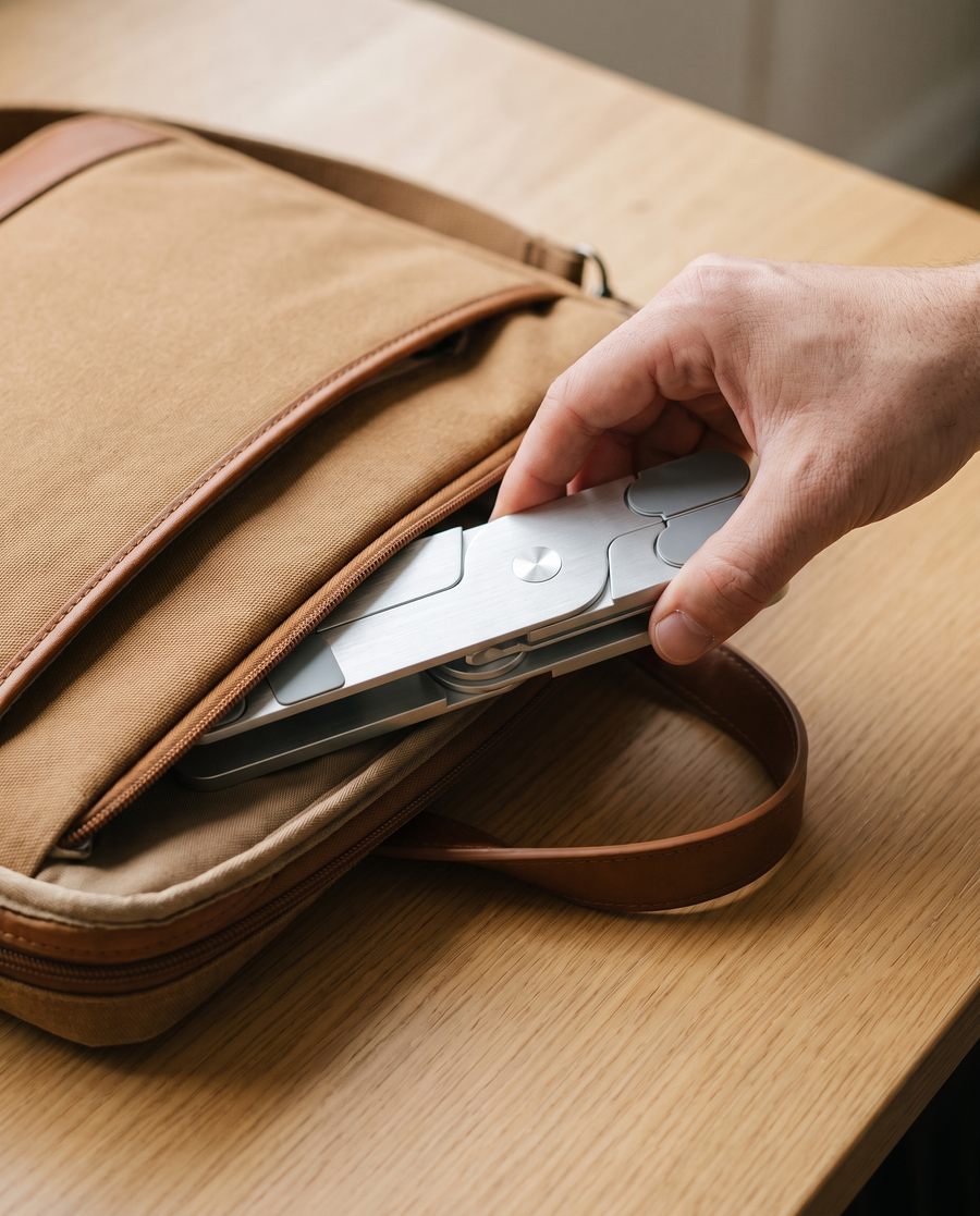 The folded Pivot being slipped into a laptop bag