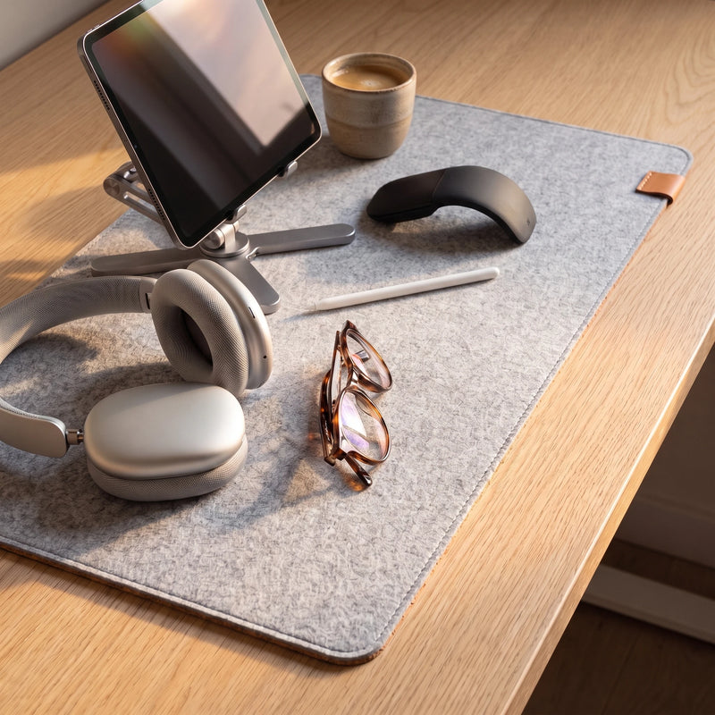 The felt desk mat in use, with a tablet on a folding stand