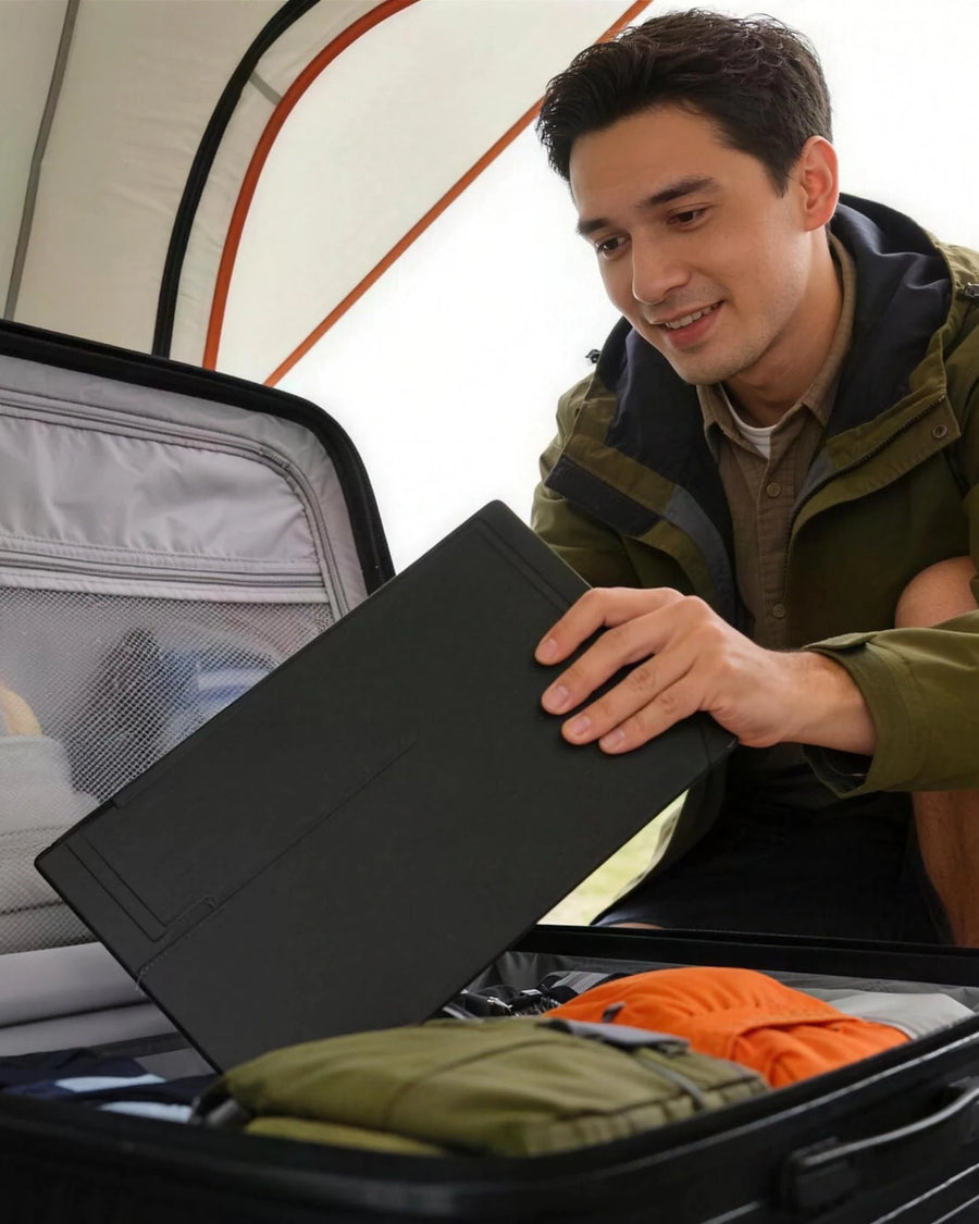 The portable monitor folded flat, going into a suitcase