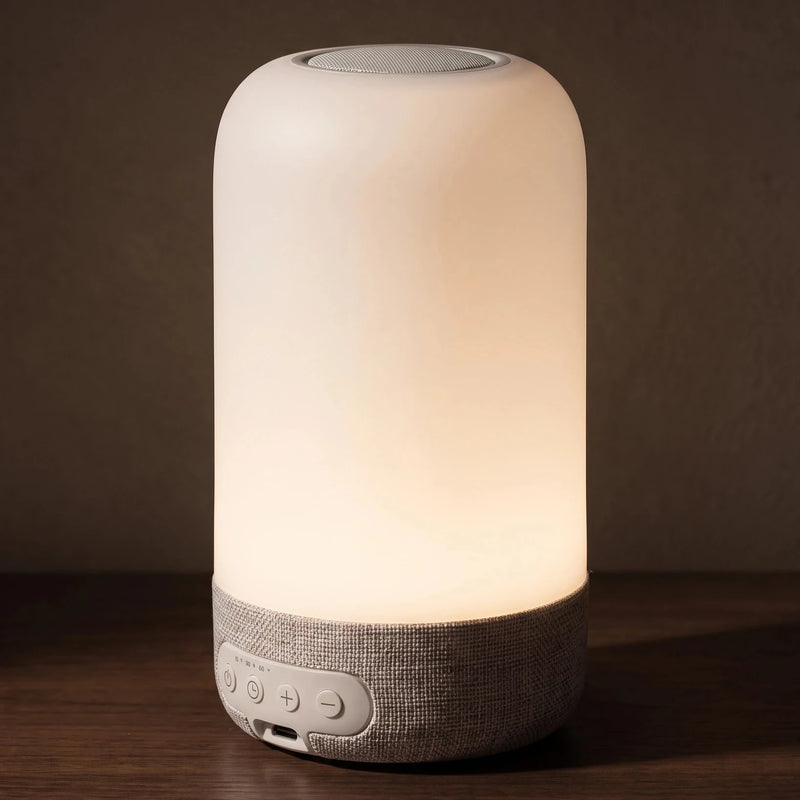 The bedside lamp — side profile, the height of a coffee mug