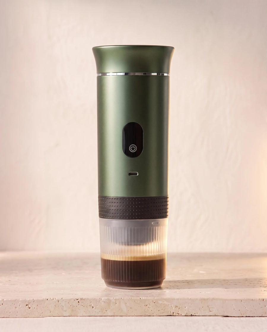 The portable espresso maker in Moss Green, lid on