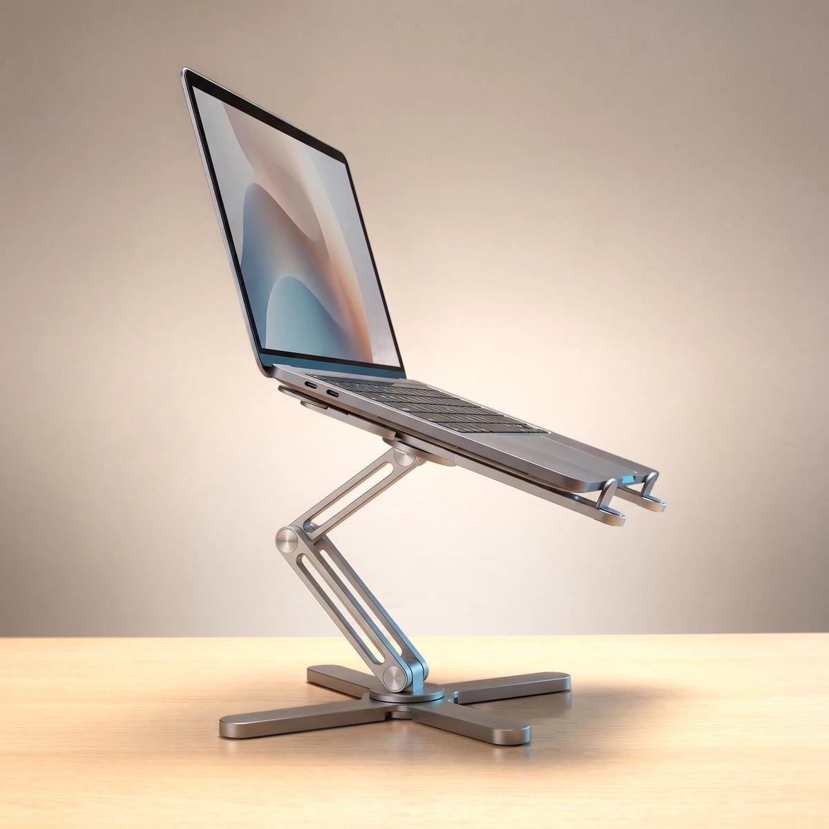 The folding laptop stand in Brushed Silver, holding a laptop at eye level