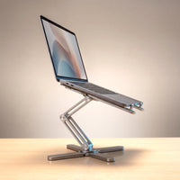 The folding laptop stand in Brushed Silver, holding a laptop at eye level