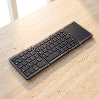 The folding keyboard in Ink, on travertine