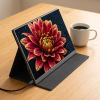 The portable monitor open on its folding case stand, a vivid photograph filling the screen, one USB-C cable connected