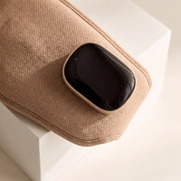 The heated eye massager — glossy charging module detail