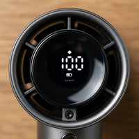 The handheld fan — circular speed readout lit at 100