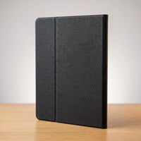 The portable monitor folded closed in its case, standing on its spine