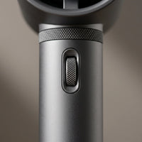 The handheld fan — knurled thumb-wheel and neck ring