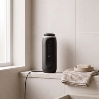The diffuser in Ink Black on a bathroom window sill