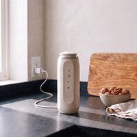 The diffuser on a kitchen counter, its cable running to a plug in the wall