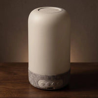 The bedside lamp — unlit, clean matte-white form