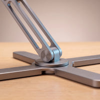 Close view of the stand's cross base and 360-degree swivel hub